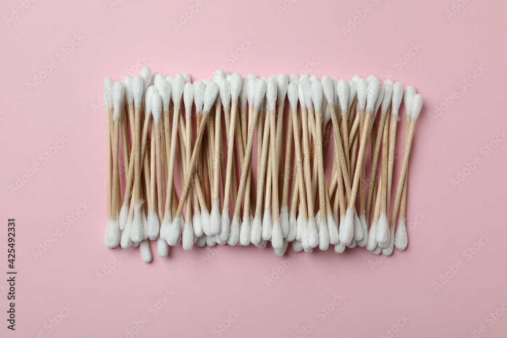 Cotton swabs on pink background, top view Cotton swabs on pink background, top view