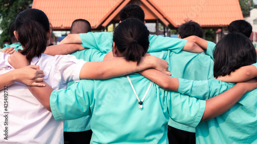 Concept of best friends,Teen group of uniform students hugging in school