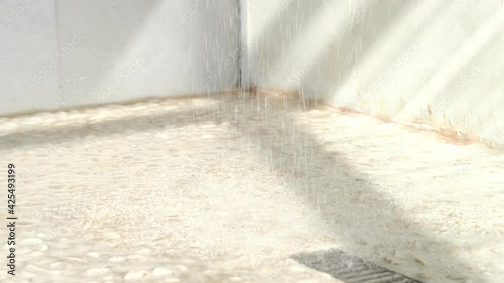 Floor drain, running water in shower. slow motion of tiled floor in a