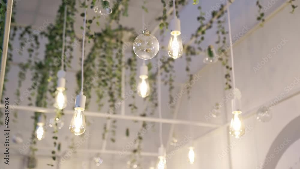 light bulbs, garlands and artificial plants hanging from the ceiling. light bulbs, garlands and artificial plants hanging from the ceiling.