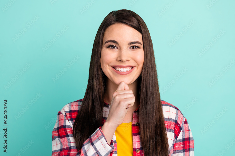 Photo of minded charming young woman hold hand chin idea smile isolated on pastel teal color background Photo of minded charming young woman hold hand chin idea smile isolated on pastel teal color background