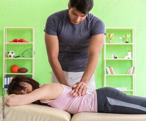 Young doctor chiropractor massaging patient