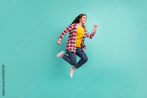 Full length profile side photo of charming young woman jump up run empty space sale isolated on teal color background