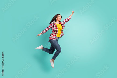 Full length body size view of attractive cheerful girl jumping striving isolated over bright teal turquoise color background