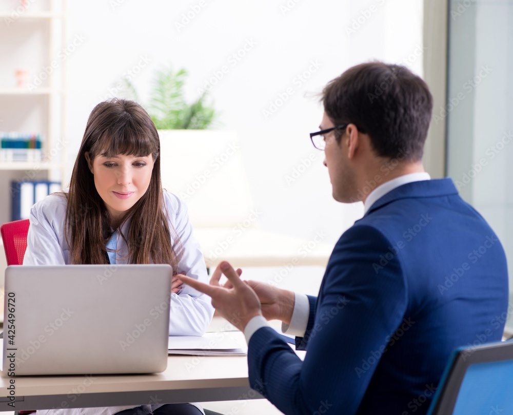 Businessman discussing health issues with doctor Businessman discussing health issues with doctor