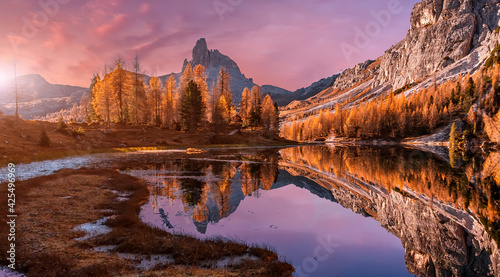 Fantastic Wild nature scenery of Dolomites Alps. Mountain landscape with perfect reflection during sunset, picturesque mountain lake in the sunny morning. Beautiful landscape background. Federa lake.
