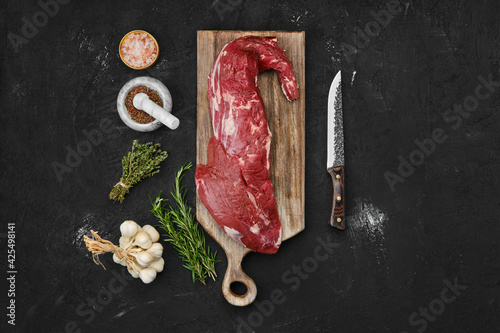 Overhead view of raw beef tri-tip loin on cutting board photo