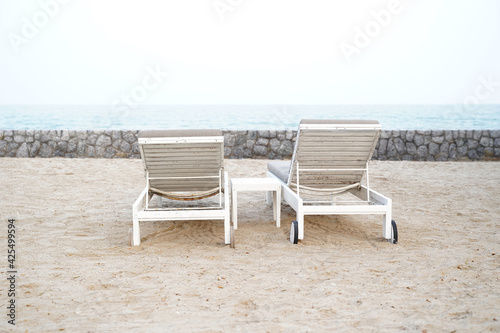 White sun loungers on the beach. Vacation holidays summer background.