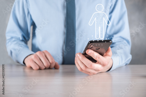 Businessman holds man person icon on dark tone background.HR Human ,people iconTechnology Process System Business with Recruitment, Hiring, Team Building. Organisation structure concept photo