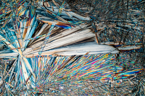Colorful microscopic view of Epsom Salt or Magnesium Sulfate heptahydrate Crystals. Abstract background texture.  captured under polarized light with a microscope.