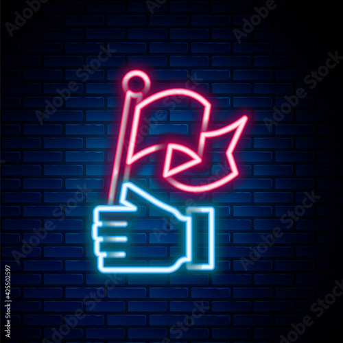 Glowing neon line Hand holding flag icon isolated on brick wall background. Victory, winning and conquer adversity concept. Colorful outline concept. Vector
