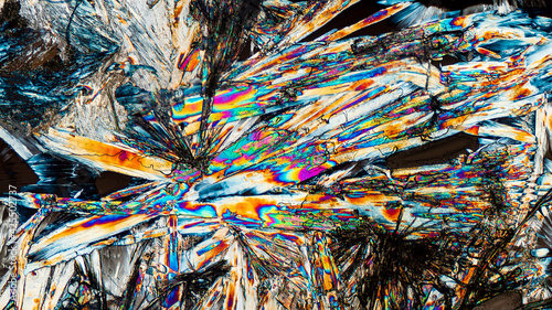 Colorful microscopic view of Epsom Salt or Magnesium Sulfate heptahydrate Crystals. Abstract background texture.  captured under polarized light with a microscope.