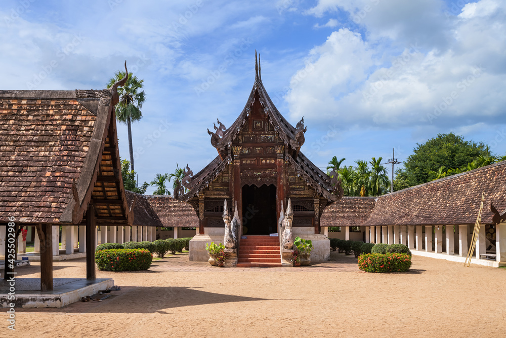 Fototapeta premium Beautiful traditional Lanna art wooden chapel church at Wat Intharawat or Ton Kwen Temple in Chiang Mai, Thailand