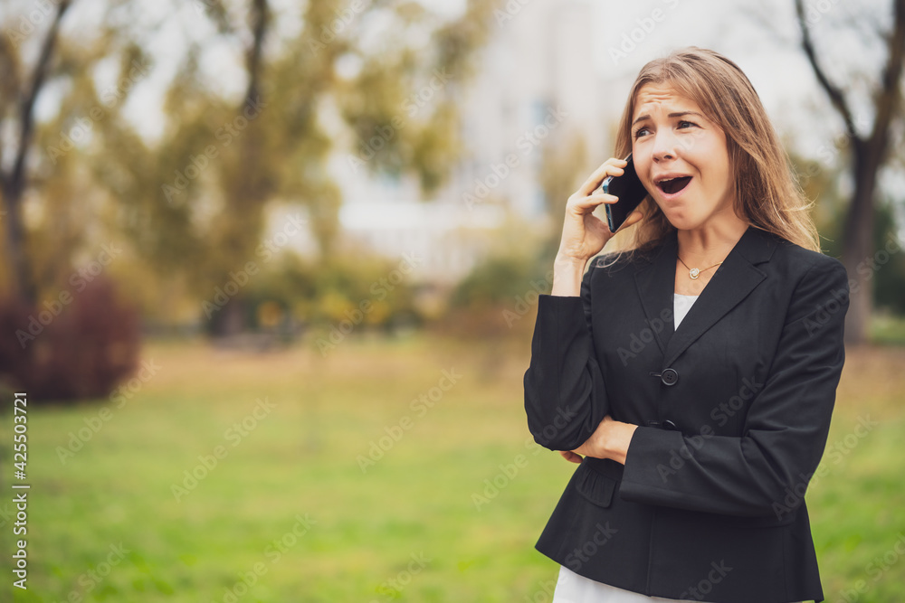 Outdoor portrait of happy businesswoman who is talking on phone. Outdoor portrait of happy businesswoman who is talking on phone.