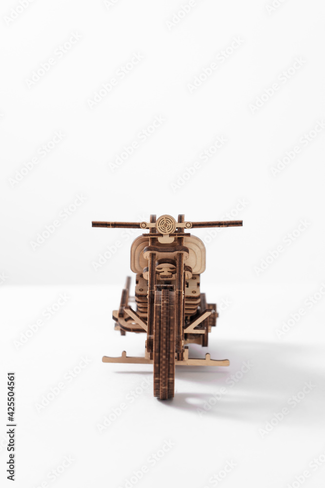 Wooden toy motorcycle on a white background a large plan
