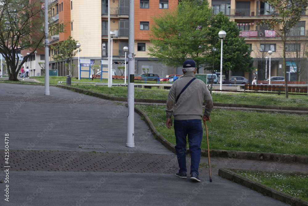 Ageing man walking in the street