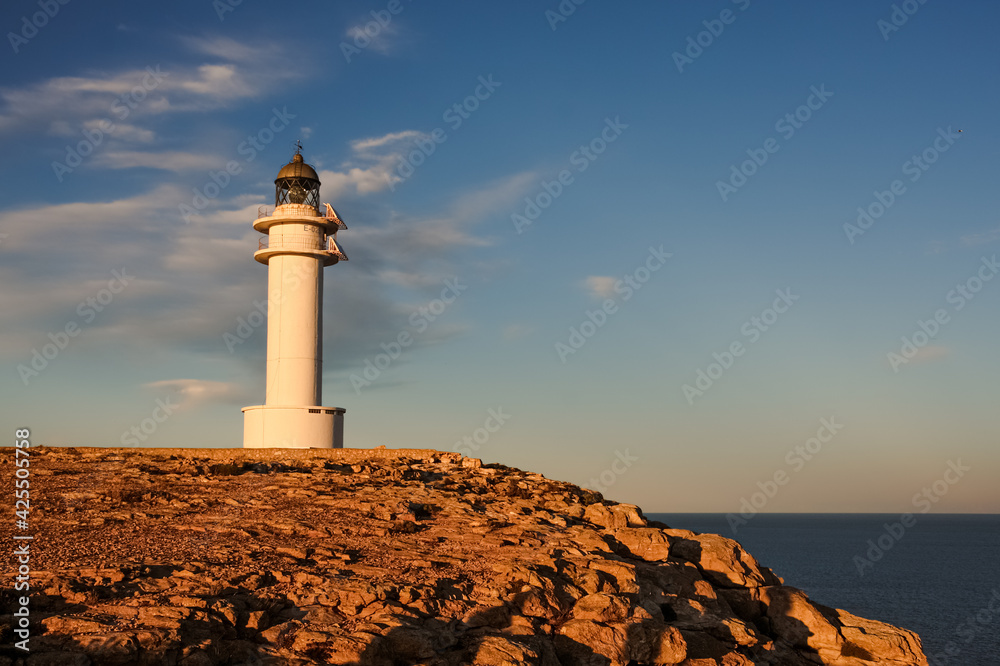 lighthouse at the coast of Formentera during sunset, beautiful blue sky