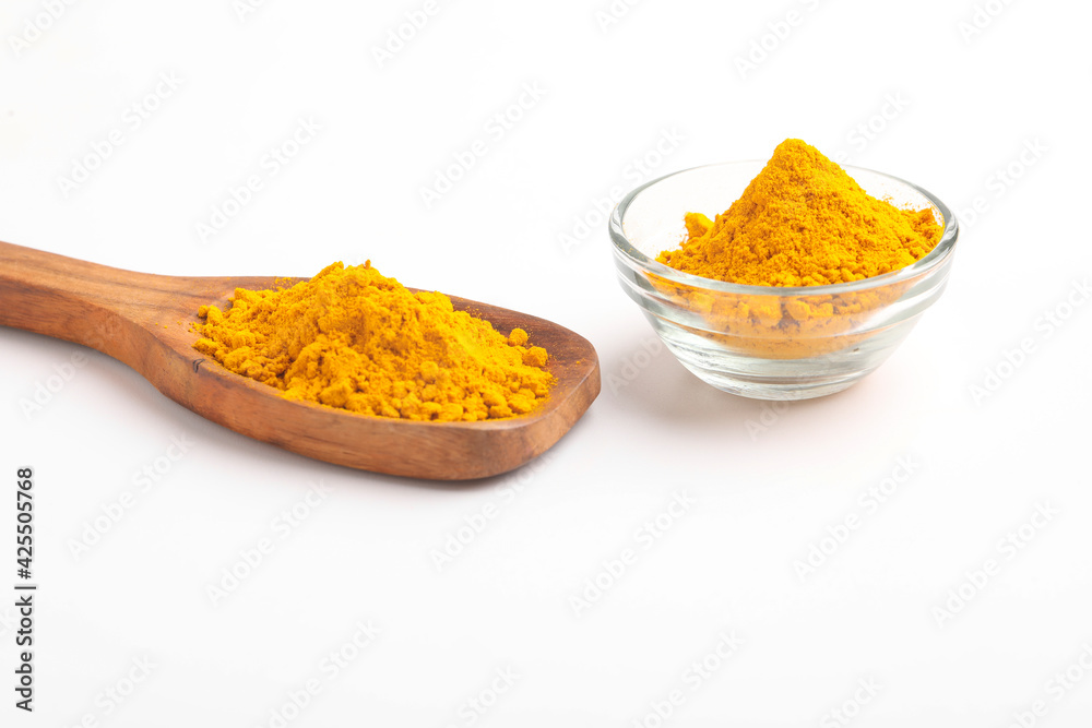 Turmeric in wooden spoon on white background. Turmeric in wooden spoon on white background.