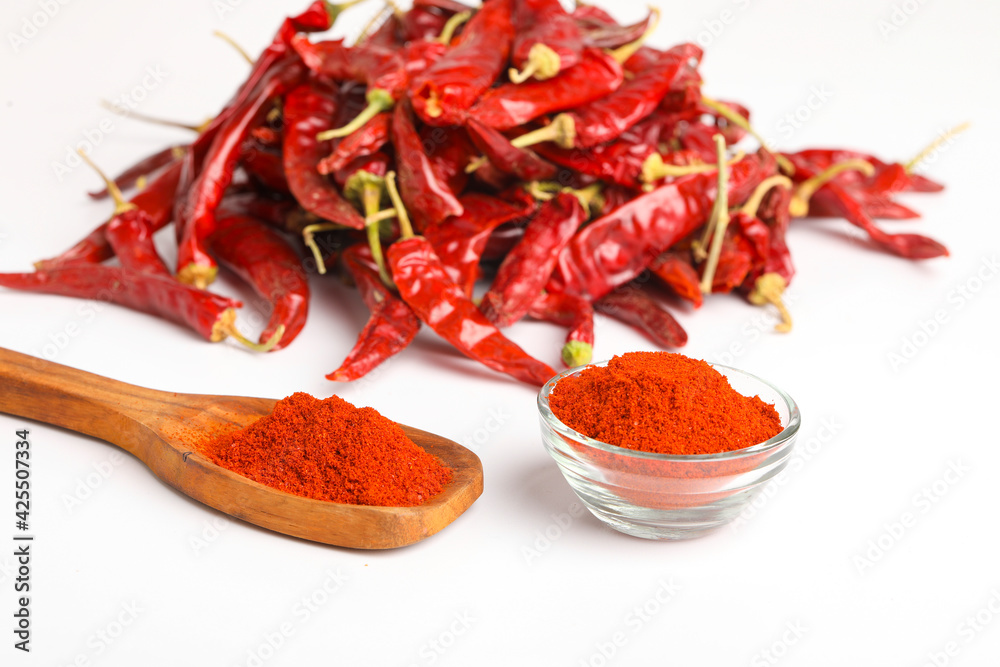 Dried red chilli and powder in wooden spoon on white background. Dried red chilli and powder in wooden spoon on white background.