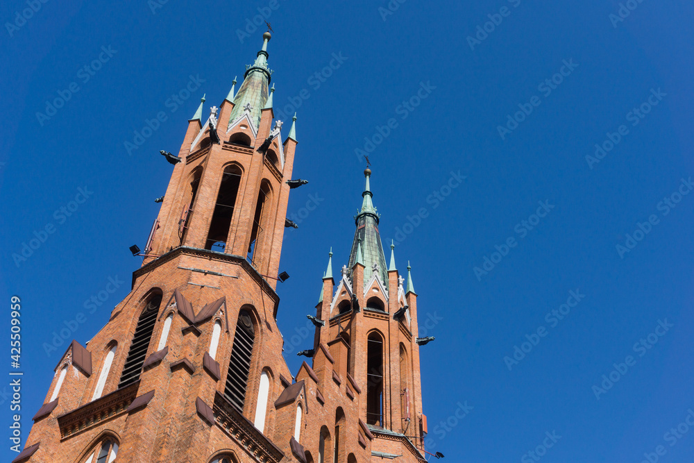 Cathedral Basilica of the Assumption of the Blessed Virgin Mary in Białystok city. Baroque style architecture. Heaven blue sky background. Red brick church in Poland.