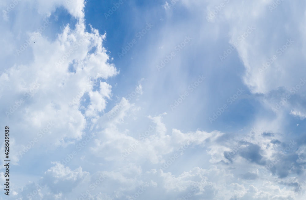 Obraz premium Beautiful view of blue sky with clouds. Beautiful shapes, partly cloudy. Colorful sunset. Natural sky background texture, beautiful color. Bright landscape in the blue sky