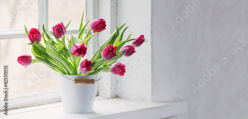 Fototapeta Naklejka Na Ścianę i Meble -  red tulips on old white windowsill