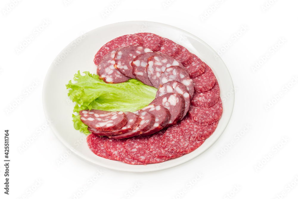 Sliced dry-cured and smoked sausages on a white dish Sliced dry-cured and smoked sausages on a white dish