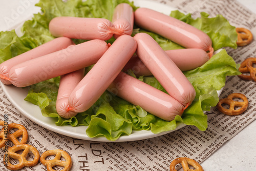 Sausages on a plate. Lots of raw sausages for fast food