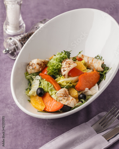Fresh salad with vegetables and meat. Seafood and greens. Restaurant menu