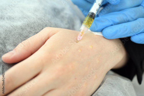 A plastic surgeon doctor does an injection of a beauty injection into the hands of an elderly woman. Hand rejuvenation concept with mesotherapy and plasmolifting stock