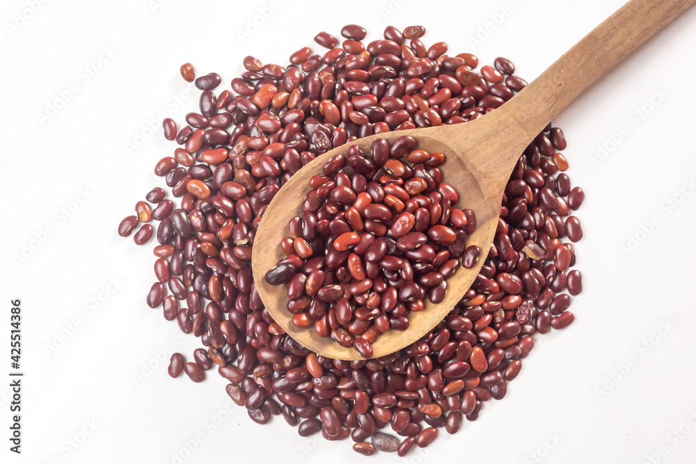 Fresh organic red kidney beans or rajma in a wooden spoon on white isolated background.