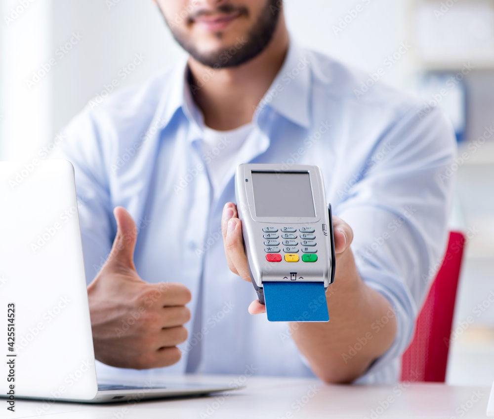 Man processing credit card transaction with POS terminal Man processing credit card transaction with POS terminal