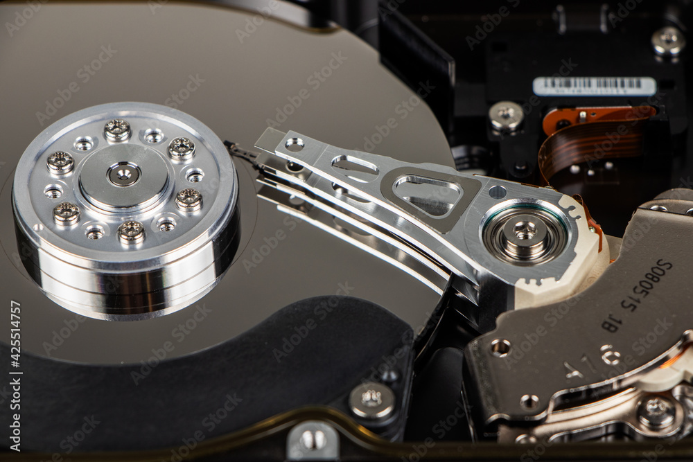 Disassembled hard drive from the computer, hdd with mirror effect. Opened hard drive from the computer hdd with mirror effects. Part of computer pc, laptop. Disassembled hard drive from the computer, hdd with mirror effect. Opened hard drive from the computer hdd with mirror effects. Part of computer pc, laptop.