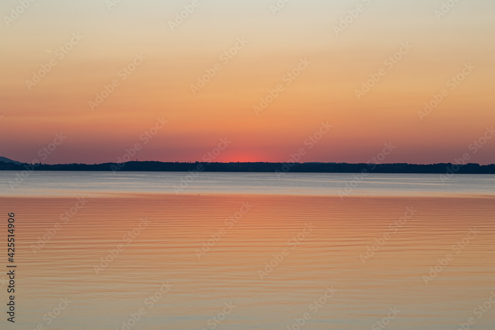 minimalistic photo of sunset over lake Chiemsee in the bavarian alps in Germany