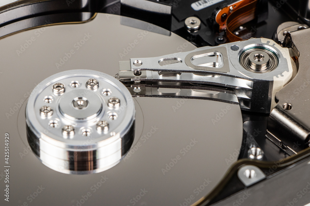 Disassembled hard drive from the computer, hdd with mirror effect. Opened hard drive from the computer hdd with mirror effects. Part of computer pc, laptop. Disassembled hard drive from the computer, hdd with mirror effect. Opened hard drive from the computer hdd with mirror effects. Part of computer pc, laptop.