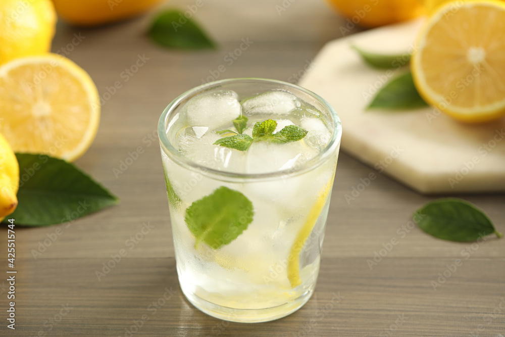 Cool freshly made lemonade in glass on wooden table, closeup Cool freshly made lemonade in glass on wooden table, closeup