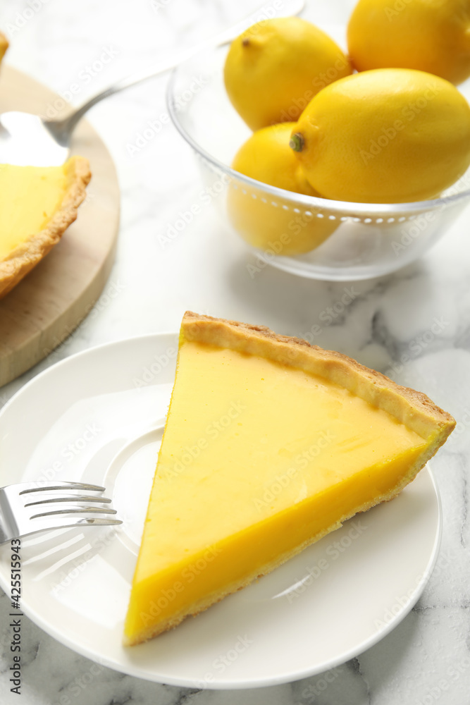 Slice of delicious homemade lemon pie on white marble table Slice of delicious homemade lemon pie on white marble table