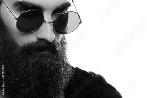 Billede på lærred Closeup photo of a bearded man wearing sunglasses in a studio