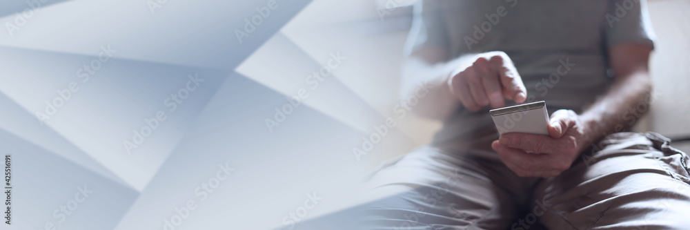 Man using his smartphone; panoramic banner Man using his smartphone; panoramic banner