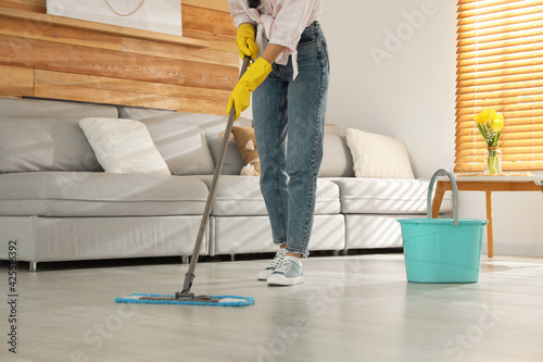 Canvastavla Woman cleaning floor with mop at home, closeup