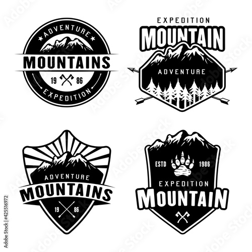 Mountains camping and outdoor adventure set of four monochrome vector emblems, labels, badges or logos isolated on white background