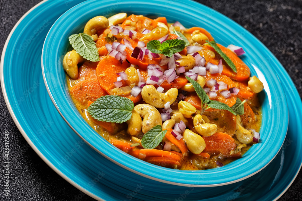 Fototapeta premium carrot curry with cashew and raisins, top view