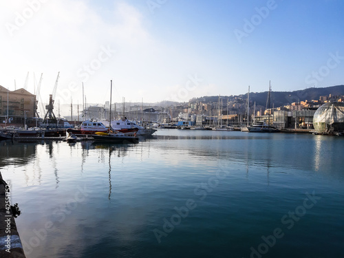 Genoa, Italy- April 01, 2021: Panoramic view of the waterfront and the old italian sea port in Genova by spring with blue sky and clear water.