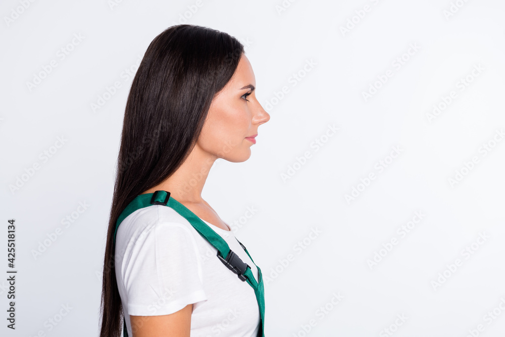 Profile photo of calm focused lady look empty space wear green overall isolated white color background Profile photo of calm focused lady look empty space wear green overall isolated white color background