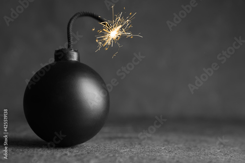 Old fashioned fuse bomb on grey table. Space for text photo