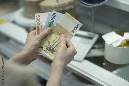 Woman counting money at home