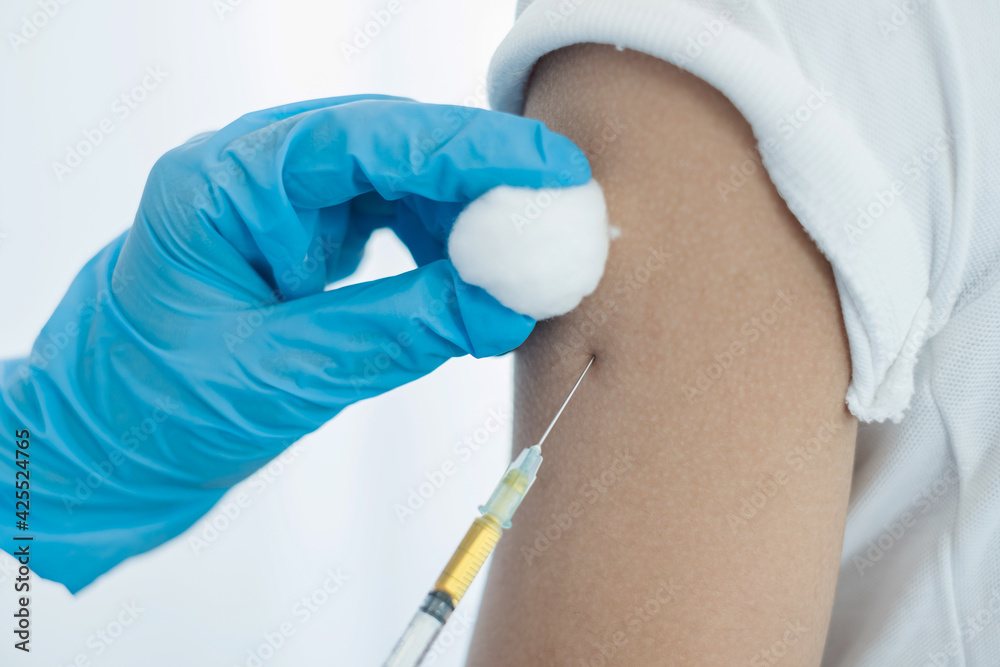 Female doctors vaccinated with syringes to prevent epidemics at hospitals, health care, and medical concepts Female doctors vaccinated with syringes to prevent epidemics at hospitals, health care, and medical concepts