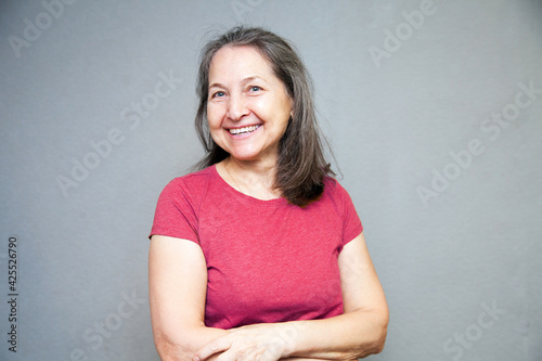 Portrait of an elderly woman on  gray background