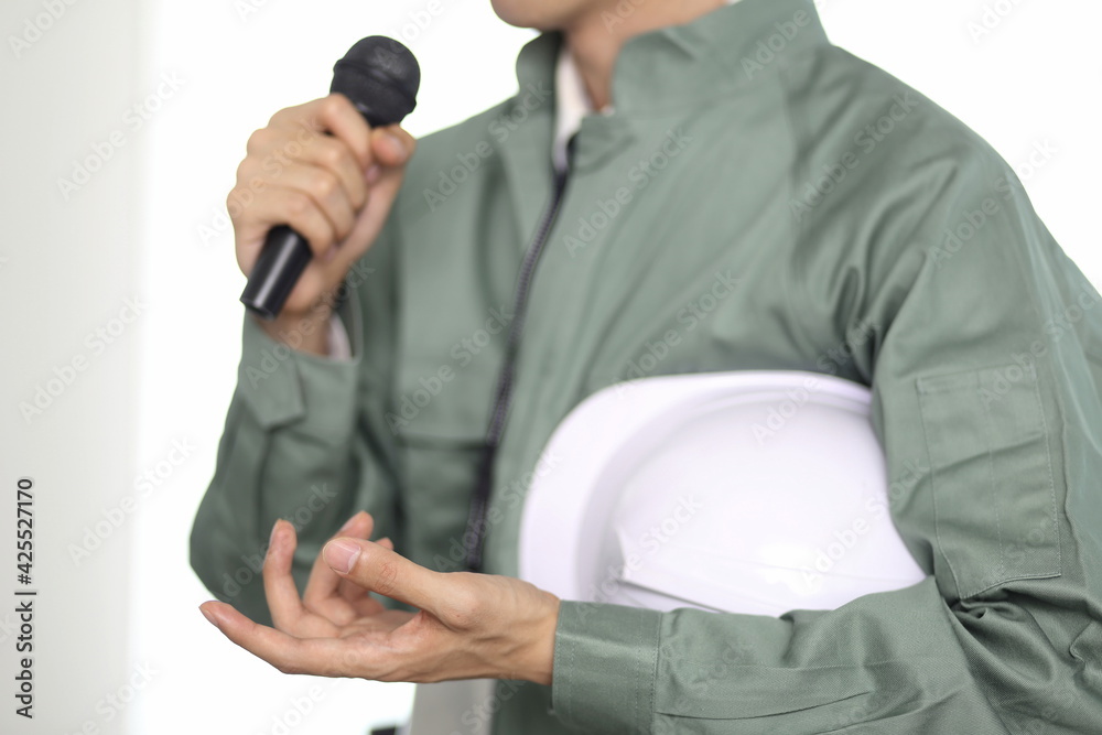 Engineer speaking with microphone at office
