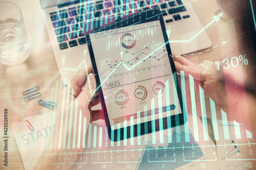 Double exposure of man's hands holding and using a digital device and forex graph drawing. Financial market concept. Double exposure of man's hands holding and using a digital device and forex graph drawing. Financial market concept.